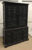 A 19th Century Flemish carved oak cupboard, the two door upper section with figural and angel carved