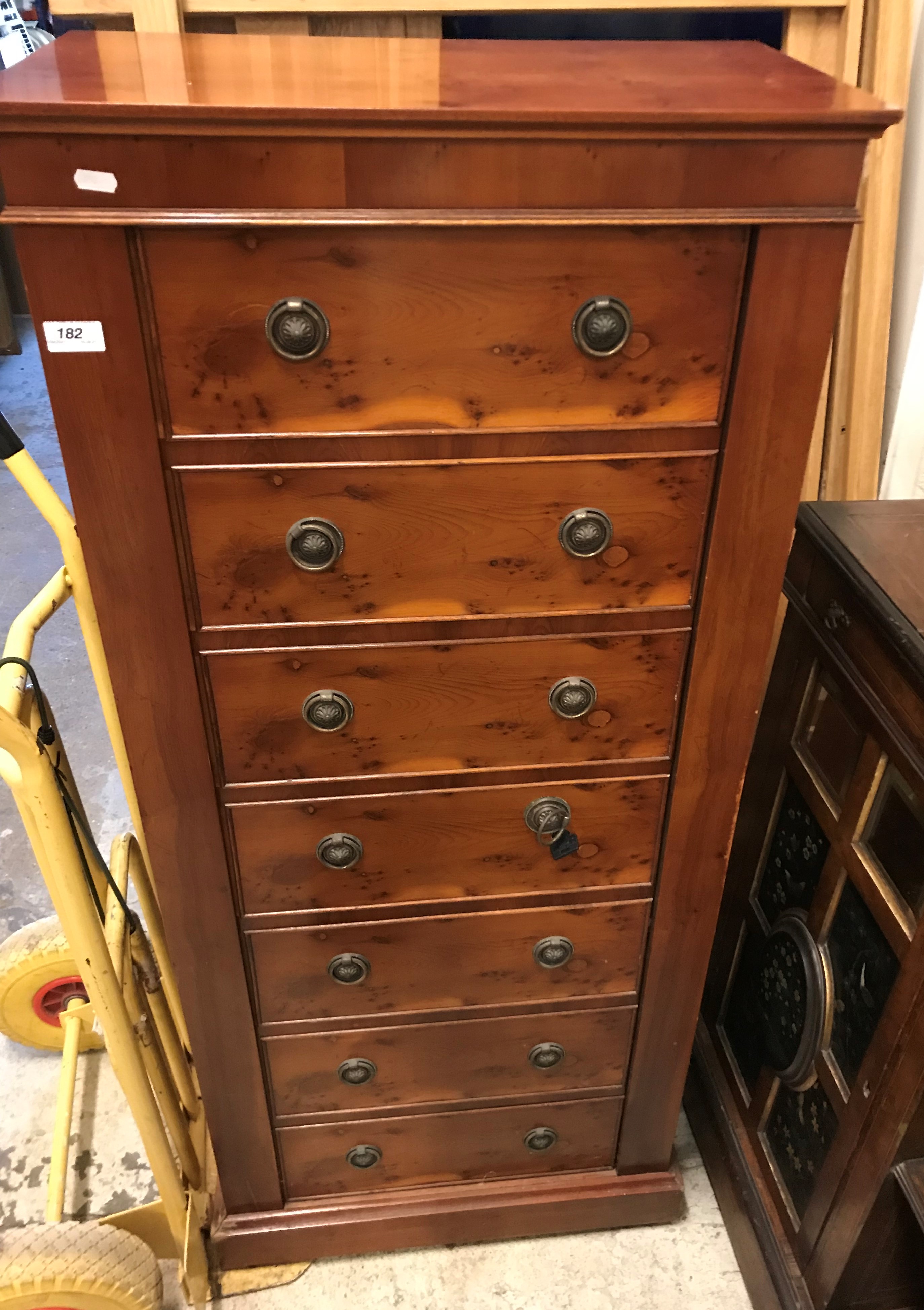 A 1980s burr yew veneered gun cabinet as a wellington chest with compliant locking systems, six