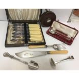 A collection of items to include a Constantia leather cased tape measure, a cased silver trefid