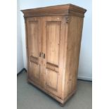 A Victorian pine two door wardrobe in the Continental style, 123.5 cm wide x 56 cm deep x 175 cm