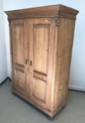 A Victorian pine two door wardrobe in the Continental style, 123.5 cm wide x 56 cm deep x 175 cm