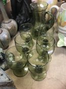 A green glass lemonade/water set comprising jug and six glasses, the jug 21 cm high