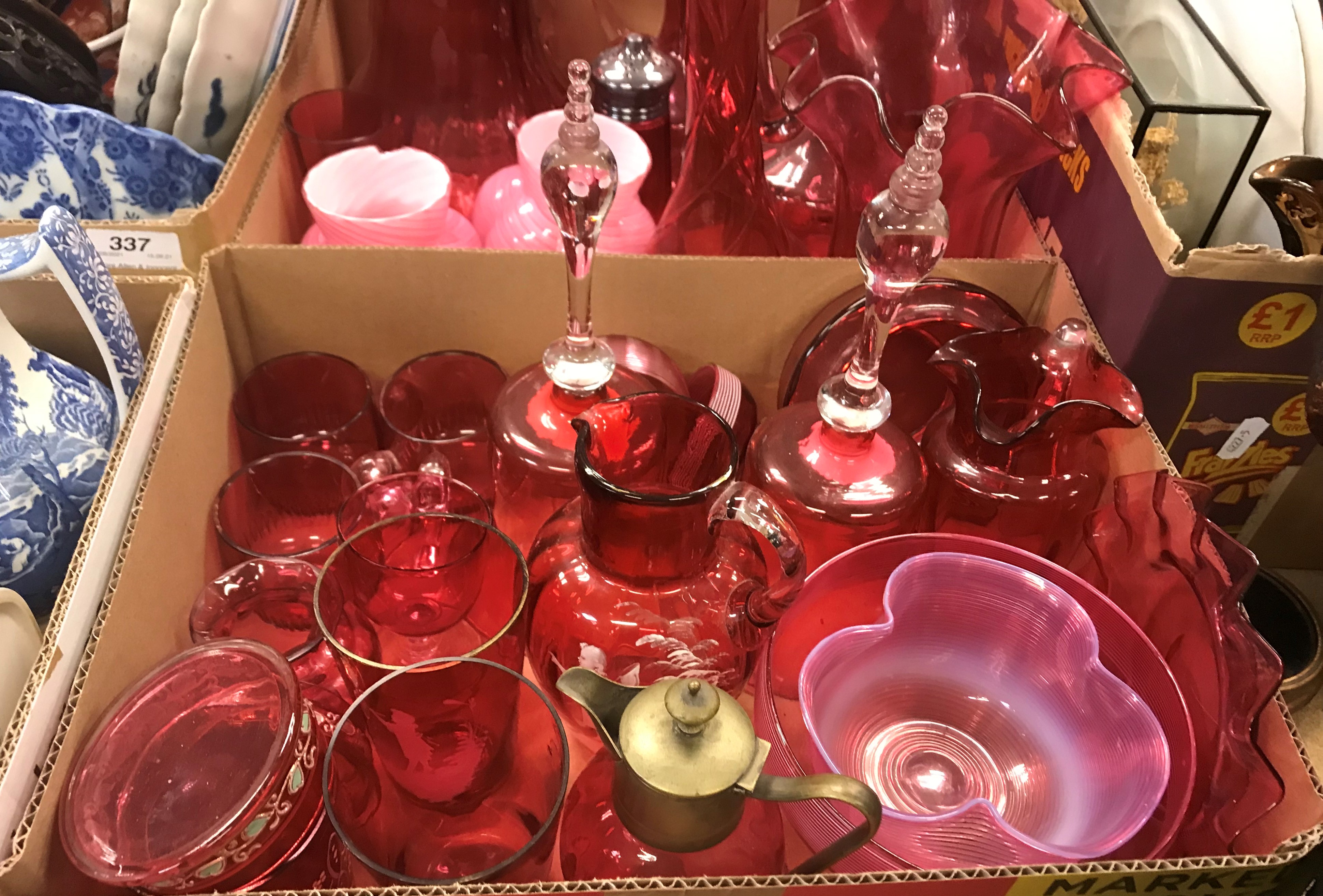 A collection of assorted cranberry glass to include Mary Gregory style decorated jug and two