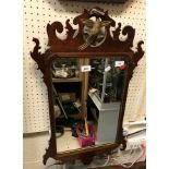 A mahogany and gilt framed wall mirror in the 18th Century manner with fretwork edge and hoho bird