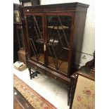 A circa 1900 mahogany display cabinet in the Georg