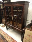 A circa 1900 mahogany display cabinet in the Georg