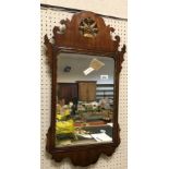 A 19th Century mahogany and gilt framed wall mirror with fretwork carved edge and floral motif to