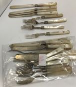 A set of twelve Victorian silver pronged mother of pearl handled fruit forks and eleven knives
