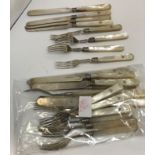 A set of twelve Victorian silver pronged mother of pearl handled fruit forks and eleven knives