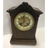 An early 20th Century mahogany and inlaid mantel clock, the dial set with Roman numerals with French