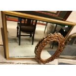 A modern gilt framed wall mirror, 98 cm x 93 cm, together with a carved wooden framed wall mirror of