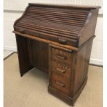 An early 20th Century oak single pedestal tambour top desk, 91 cm wide x 49 cm deep x 105 cm high,