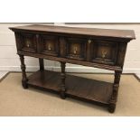 A 20th Century oak dresser in the 17th Century style, the plain top above two drawers on turned