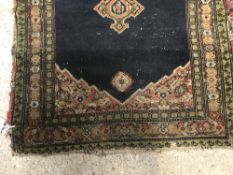 A Shenna rug, the central panel set with three med