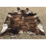 A Brindle Cow hide rug, bearing "Bureau Veritas" paper label verso and handwritten label