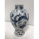 A 19th Century Kangxi baluster vase with blue and white floral spray and bird decoration, bears four