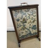 A circa 1900 rosewood framed fire screen with silk needlework panel of stag and blossoming tree (