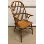 A modern oak Thames Valley style stick back elbow chair with shaped seat on turned supports united