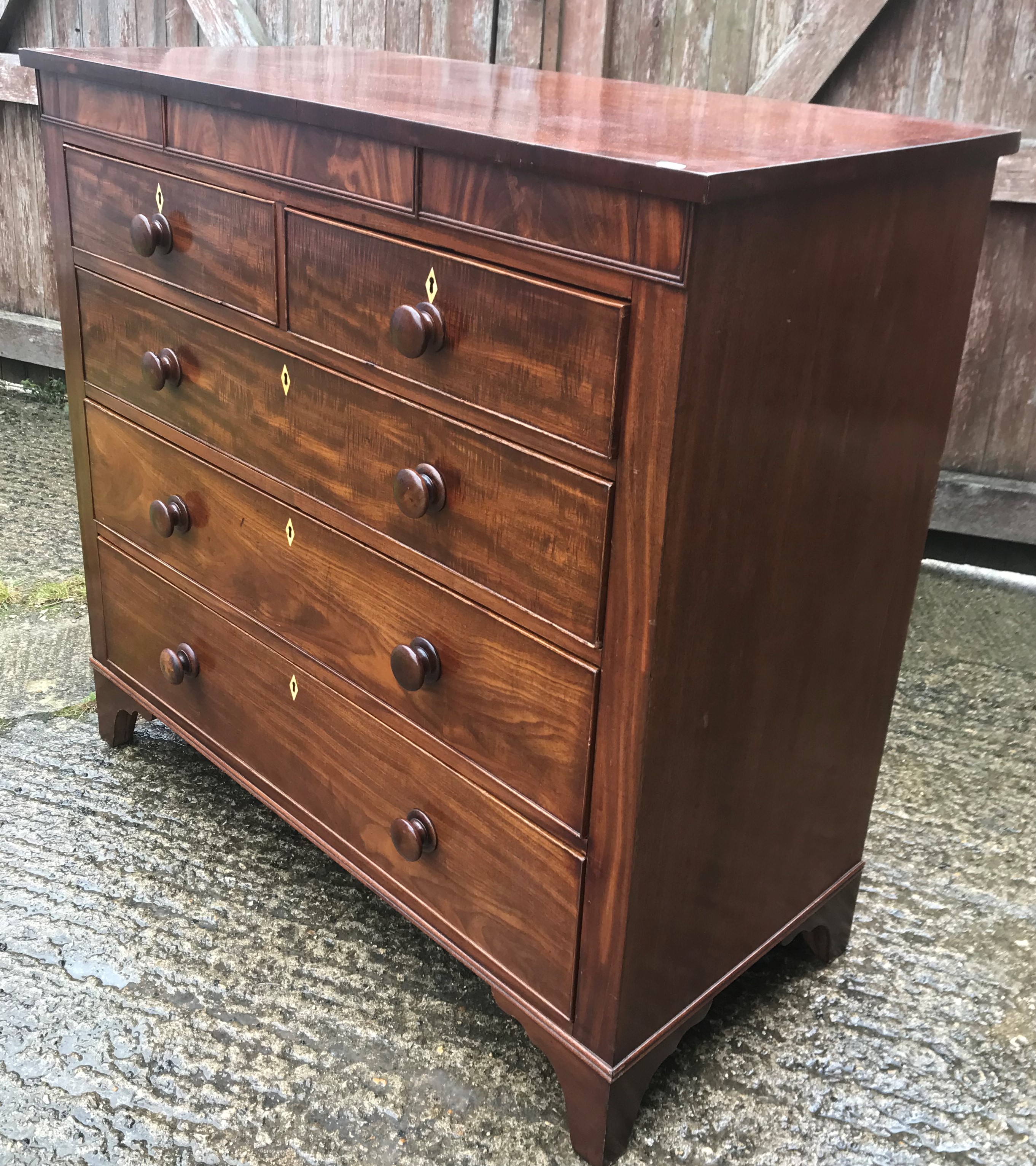 A Victorian mahogany chest of drawers, the plain top over two short and three long drawers to