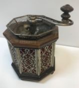 An unusual early 20th Century coffee grinder of octagonal form with mahogany and inlaid top and base