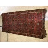 A Turkamen carpet, the central panel set with repe