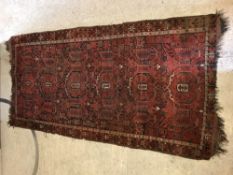 A Turkamen carpet, the central panel set with repe