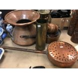 A large Middle Eastern style two handled copper pot with flared rim 28.5 cm high, a brass shell case
