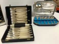 A mahogany cased mother of pearl handled twelve place fish knife and fork set, an onyx chess set,