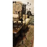 A 20th Century pair of black painted wrought iron five-light candlestands on open barley twist