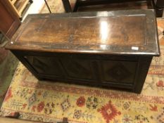 A circa 1700 oak coffer, the panelled top over a f