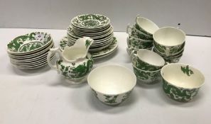 A Coalport green five toed dragon decorated tea se