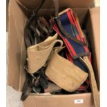 A suitcase containing various leather pony tack and a box of various tack including girths, bridles,