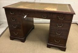 A modern mahogany double pedestal desk in the 19th Century manner, the tooled and gilded leather