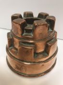 A Victorian copper jelly mould of castellated form stamped "V. Benoist, 36 Piccadilly" 10.3 cm high