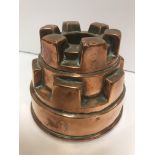 A Victorian copper jelly mould of castellated form stamped "V. Benoist, 36 Piccadilly" 10.3 cm high