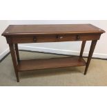 A modern cherrywood two-drawer side table on square tapered legs united by an under-tier (124.5 cm W