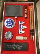 A modern Chinese calligraphy set with six brush pens, ink stone, pen rests, seal, etc, in fabric