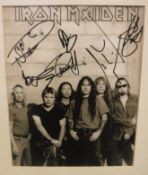 A framed and glazed photographic portrait study of IRON MAIDEN, signed by the band, 38 cm x 30.5