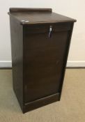 A mid 20th Century oak three section tambour fronted cabinet, 124 cm wide x 36 cm deep x 120 cm