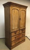 A Victorian mahogany linen press, the moulded cornice over two arched panelled doors enclosing