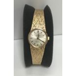 A ladies 9 carat gold cased Omega wristwatch, the dial set with numeral markers and bark textured