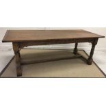 A modern oak refectory style dining table, the plank top with cleated ends and single extra leaf,