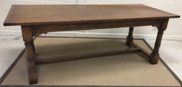 A modern oak refectory style dining table, the plank top with cleated ends and single extra leaf,