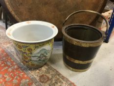 An oak bucket with brass coopered rings and swing handle, 31 cm high excluding handle x 32 cm