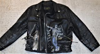 A cowhide leather motorcycle jacket with hand painted decoration depicting various Iron Maiden Eddie