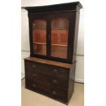 A Victorian oak bookcase cabinet, the two glazed doors enclosing two shelves over three long