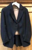 A black side saddle hunt coat by Roberts & Carroll Limited Cork Street London, approx size 10