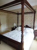 A modern mahogany four poster bedstead in the 19th Century manner, on foliate carved and barley-