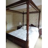 A modern mahogany four poster bedstead in the 19th Century manner, on foliate carved and barley-
