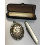 A yellow metal mounted bone cigarette holder, cased, together with a mother of pearl handled